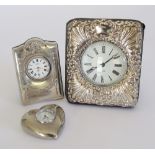 A hallmarked London 1953 sterling silver mounted portable desk clock, with pressed scroll and