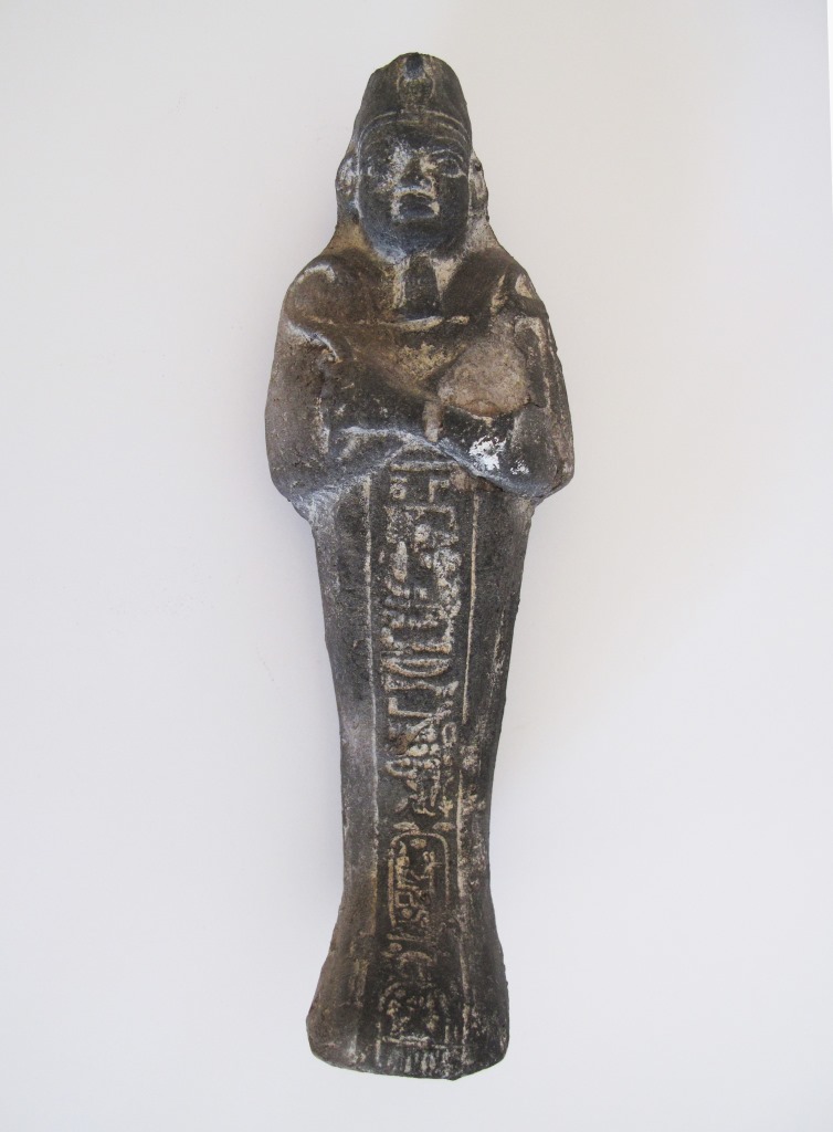 An Egyptian grey ceramic shabti - figure of a mummy. A shabti is a small human figure representing a