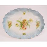 An oval English porcelain meat platter with a turquoise serpentine border decorated with transfer