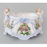 An Ernst Bohne (& Söhne) porcelain jardinière numbered 2741 with two putti handles, decorated with