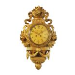 A Swedish giltwood Cartel clock, the ribbon-tie and husk swag above an arabic dial, the dial