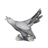 A Danish porcelain 'Bing & Grondahl' model of a squawking pigeon with tail feather aloft, no.1770.