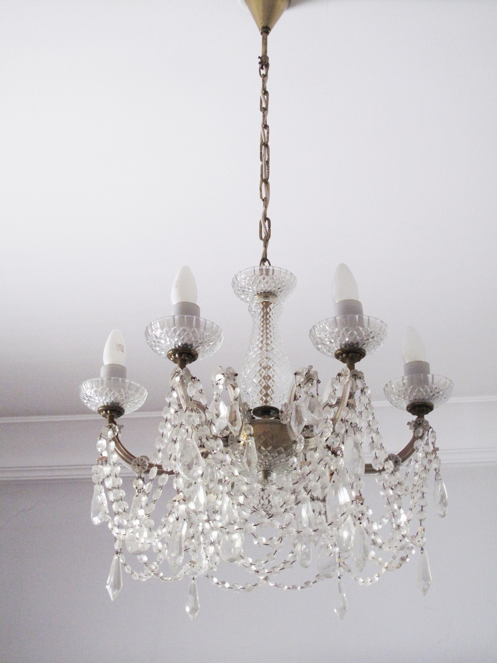 Georgian style six branch chandelier with facet cut crystal drops. The lamp shades are not included.