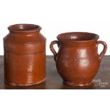 Two pieces of Pennsylvania redware, 19th c., to include a jar and a handled vase, 6" h. and 5" h.