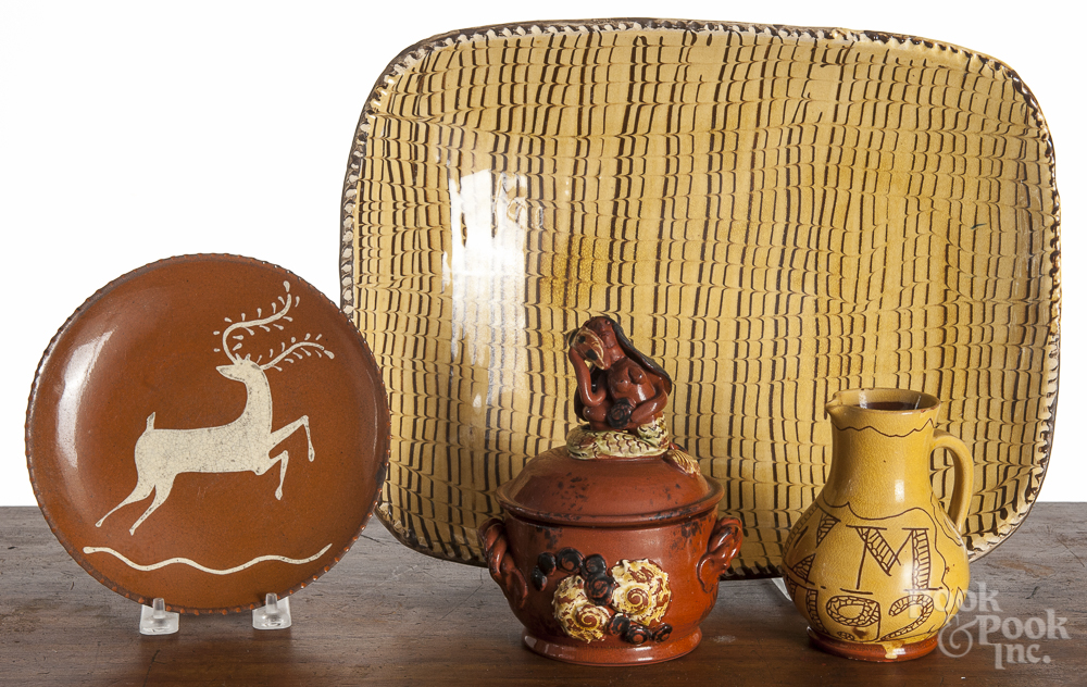 Four pieces of contemporary redware, to include a Williamsburg loaf dish, 15 1/2" w., a Williamsburg