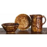 Three pieces of Bennington type pottery, 19th c., to include a pitcher, 8 1/4" h., a pie plate, 9"