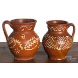 Two Mexican slip decorated redware pitchers, 19th c., 6 3/4" h. and 6 1/4" h. Tallest - glaze