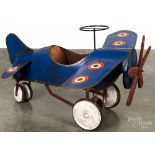 Pressed steel monoplane pedal car, ca. 1940, having removable wings, a leather seat, and a wooden
