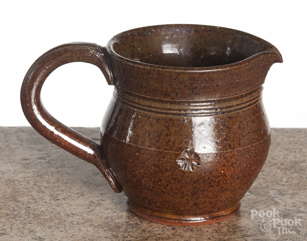 R. R. Stahl redware cream pitcher, signed and dated 1953, with a floral stamp around the waist, 3