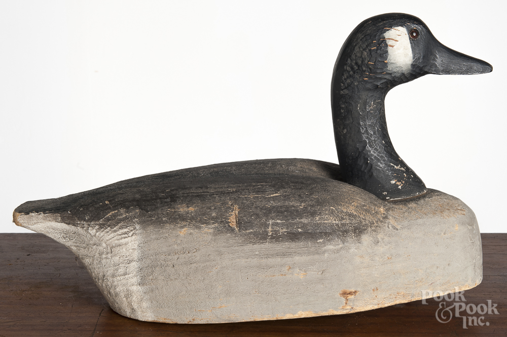 Herters carved and painted goose decoy, mid 20th c., 18" l. All over paint wear, stamped Don