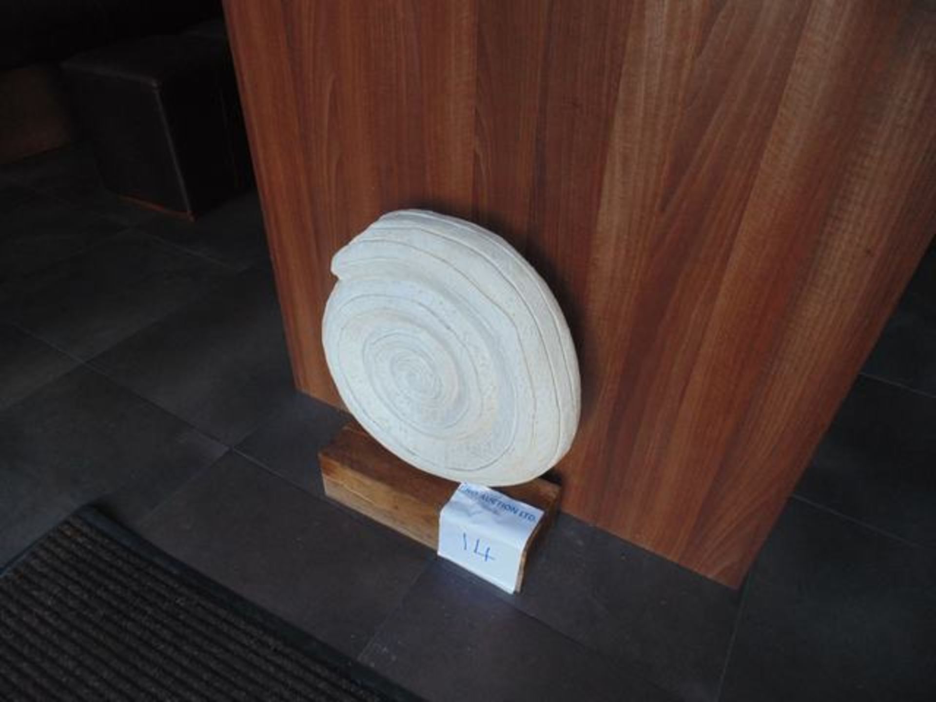 An ornametal sculpture on wood plinth
