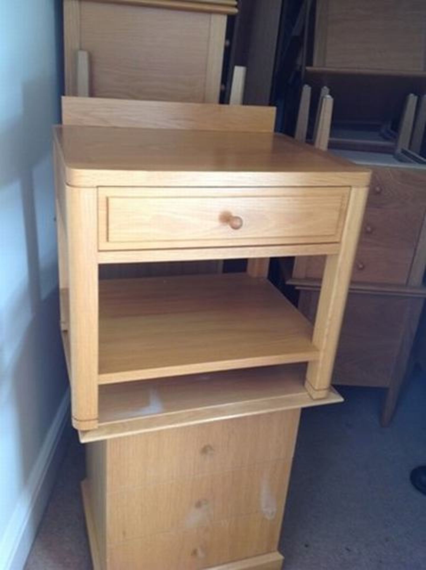 A pair of bedisde cabinets with drawer