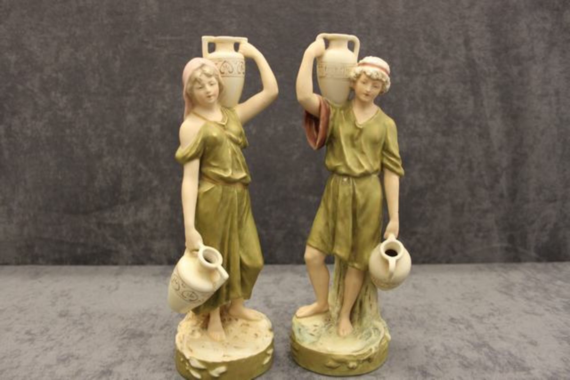 Royal Dux (Bohemia)  pair of Figures of Arab Water Carriers, Circa 1900 – 1918,, each holding two