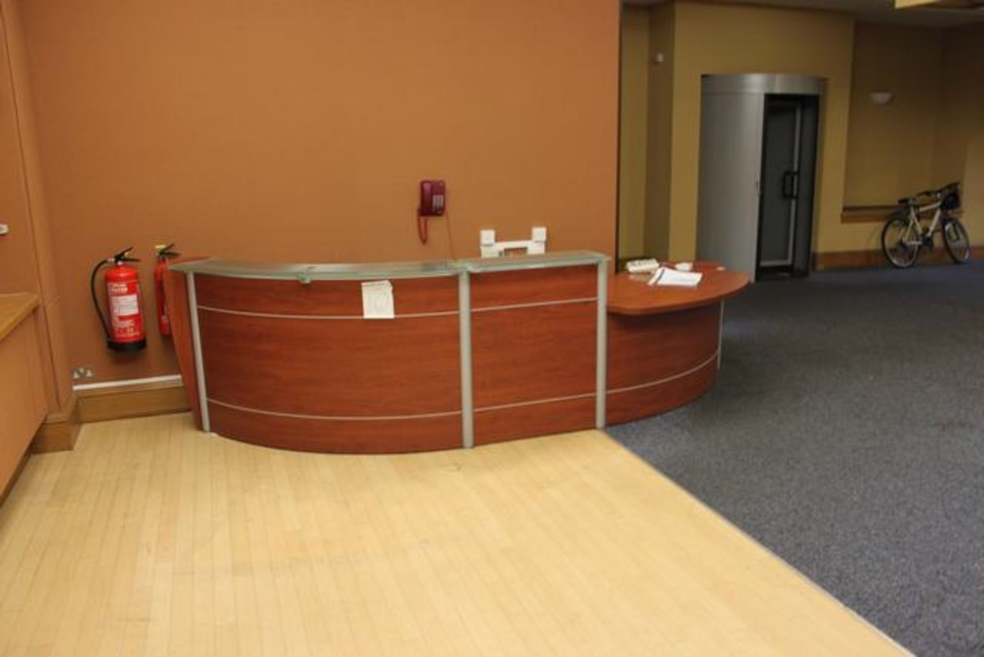 Reception counter horseshoe shaped wooden veneer frontage and working space with elevated safety