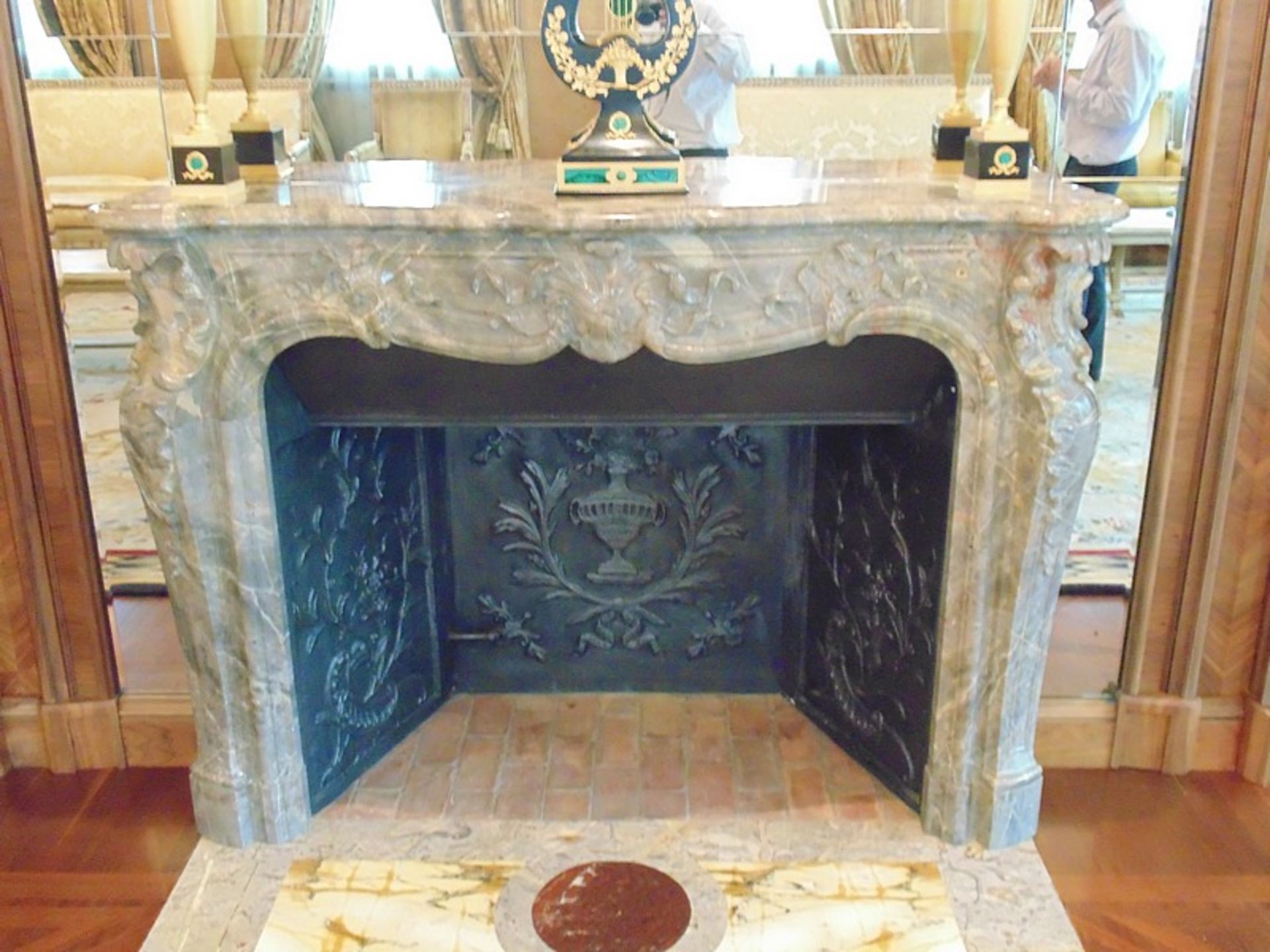 A French Louis XV Pompadour antique fireplace, finely carved in Italian Bardiglio black veined