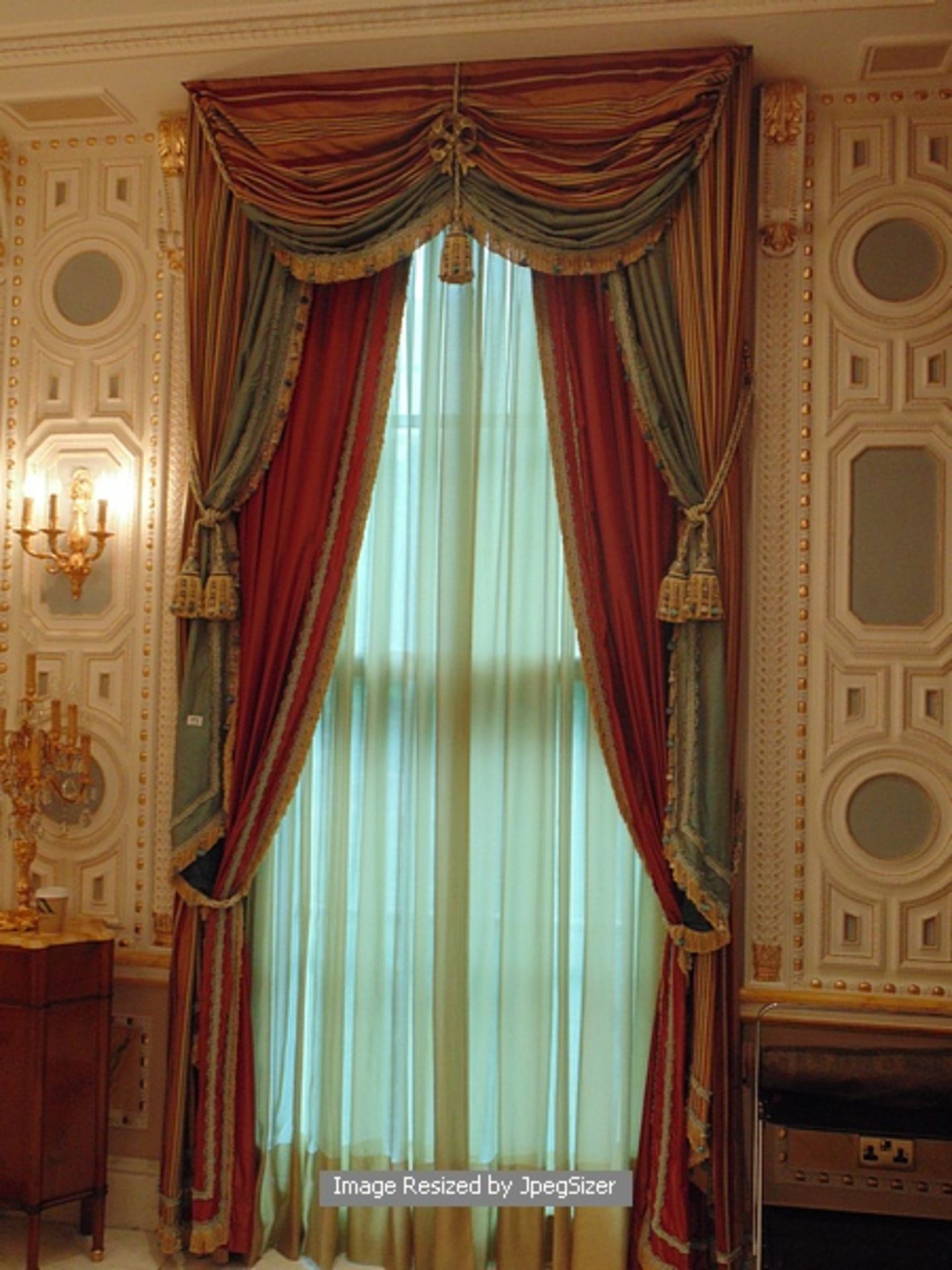 A pair of gold and aquamarine curtains supplied by Jacquard from Rudolph Ackermann`s A series design