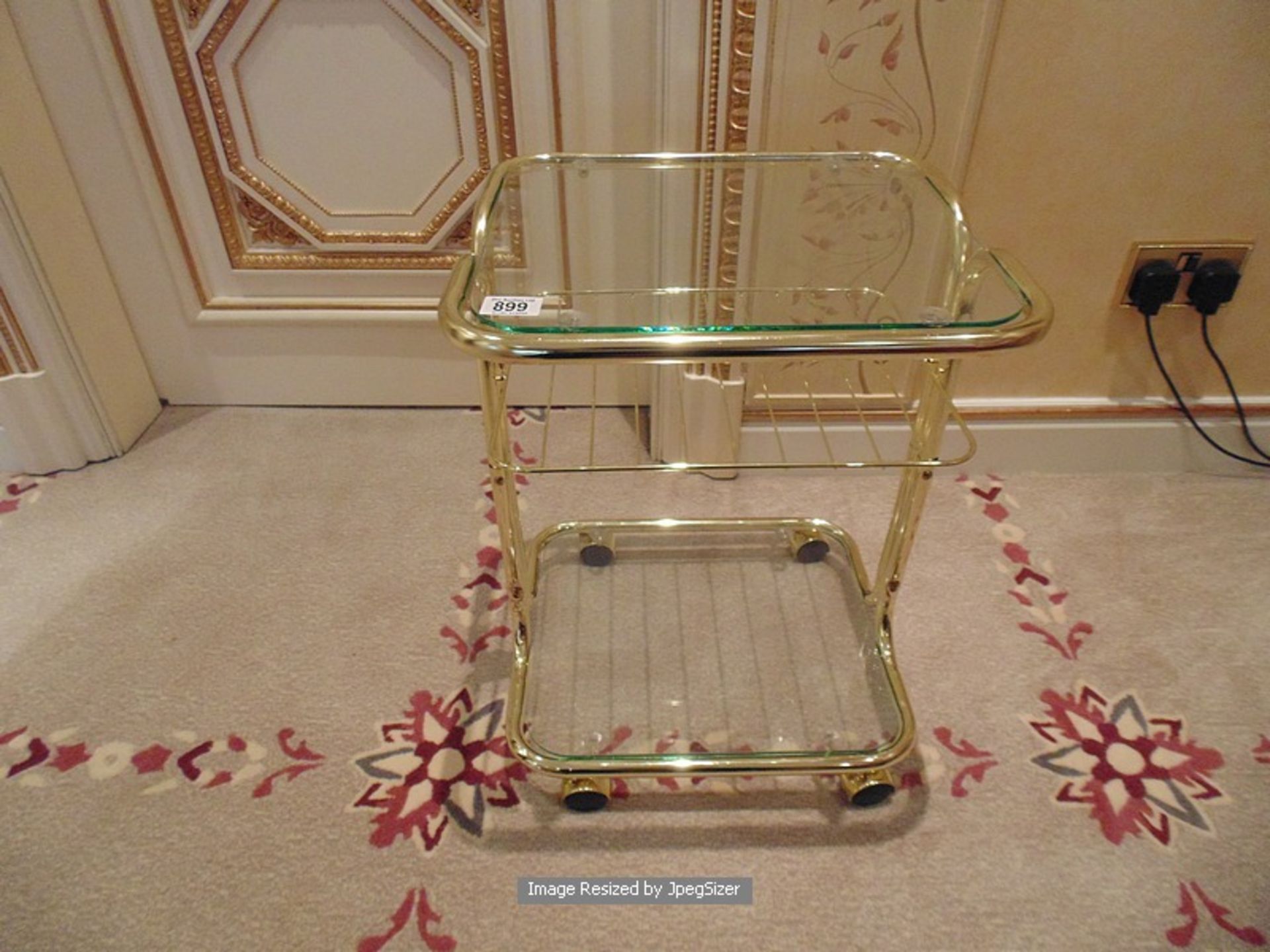 A mobile two tier brass and silvered drinks trolley with glass top and base shelf 410mm x 360mm x