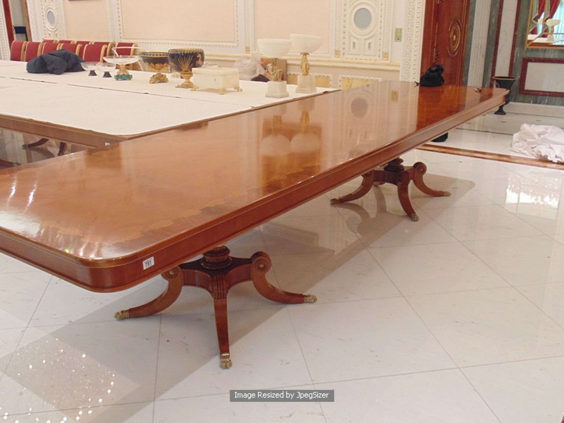 A Regency style mahogany and rosewood banded dining table, the mirror veneered top enclosed by - Image 4 of 7