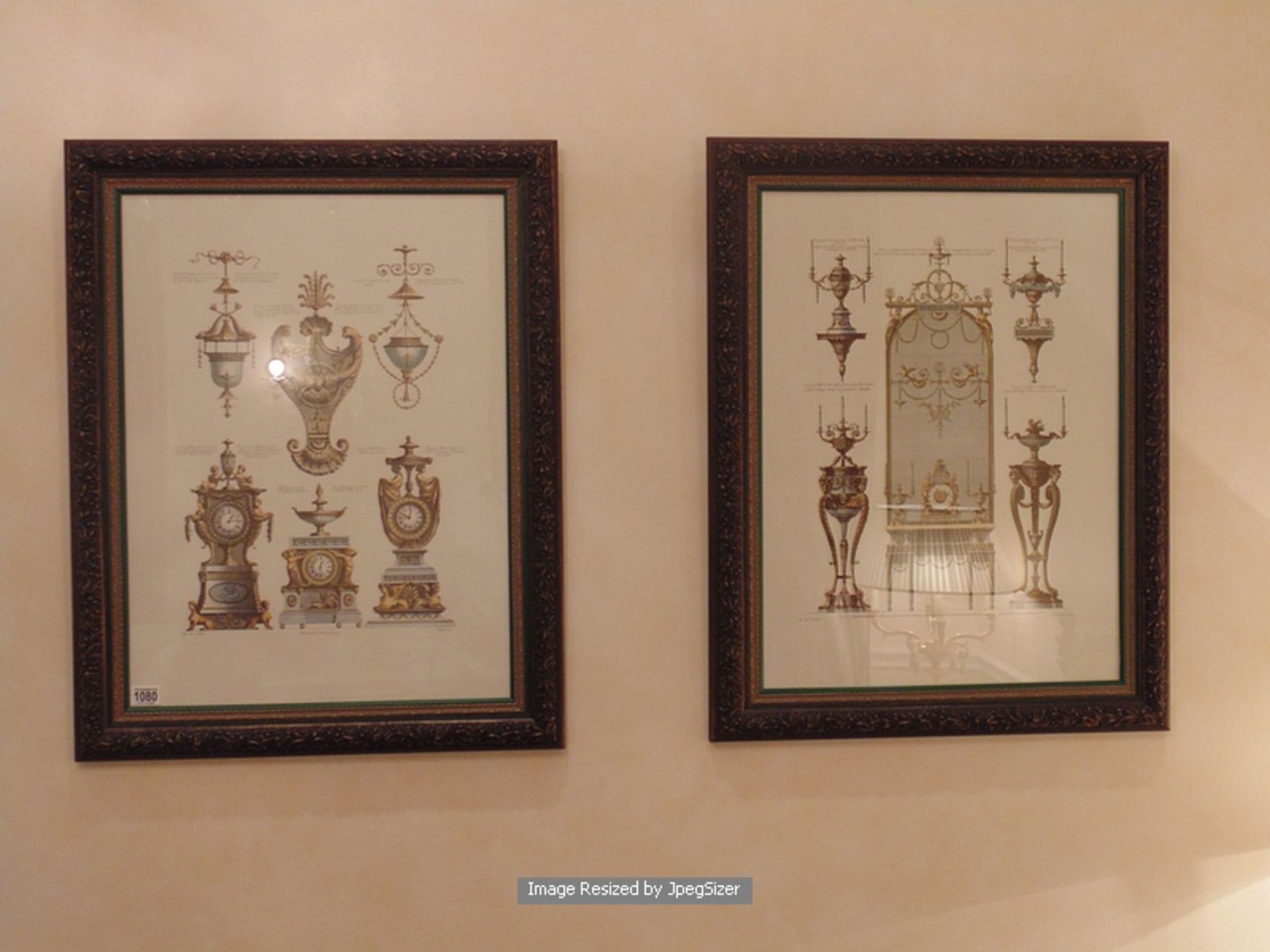 A pair of dark wooden framed prints depicting time pieces and candelabras 640mm x 820mm