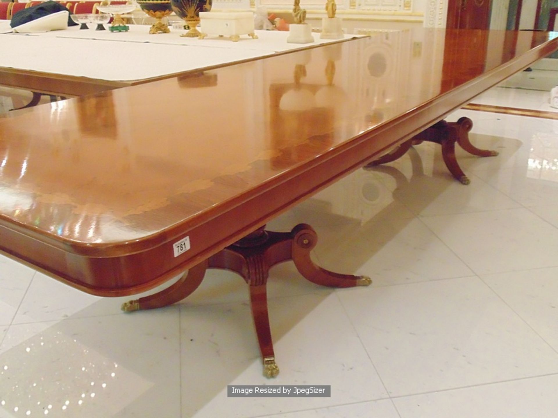 A Regency style mahogany and rosewood banded dining table, the mirror veneered top enclosed by - Image 3 of 7