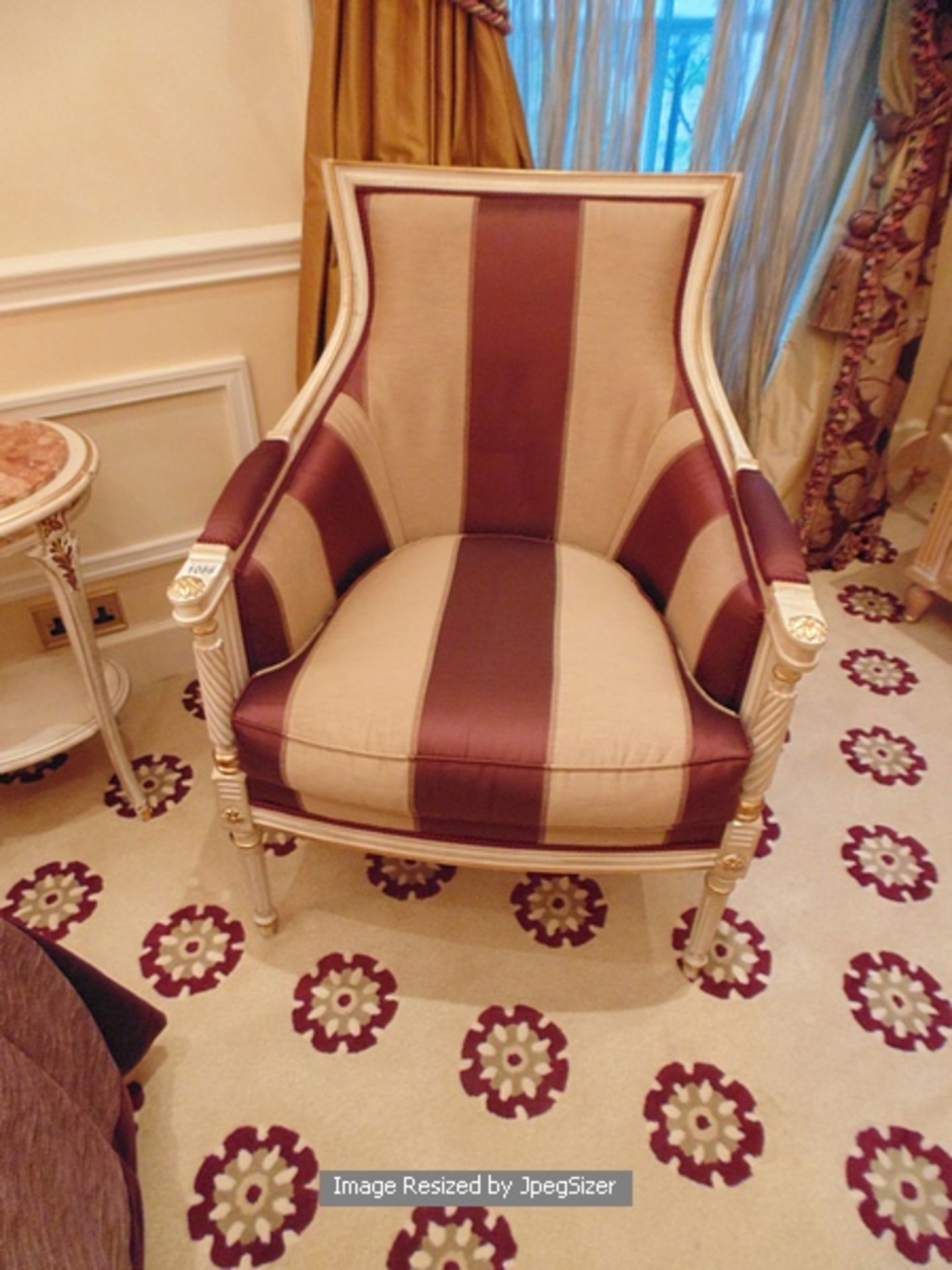 Italian Neoclassical painted and parcel gilt upholstered Bergere, upholstered in gold stripe fabrics