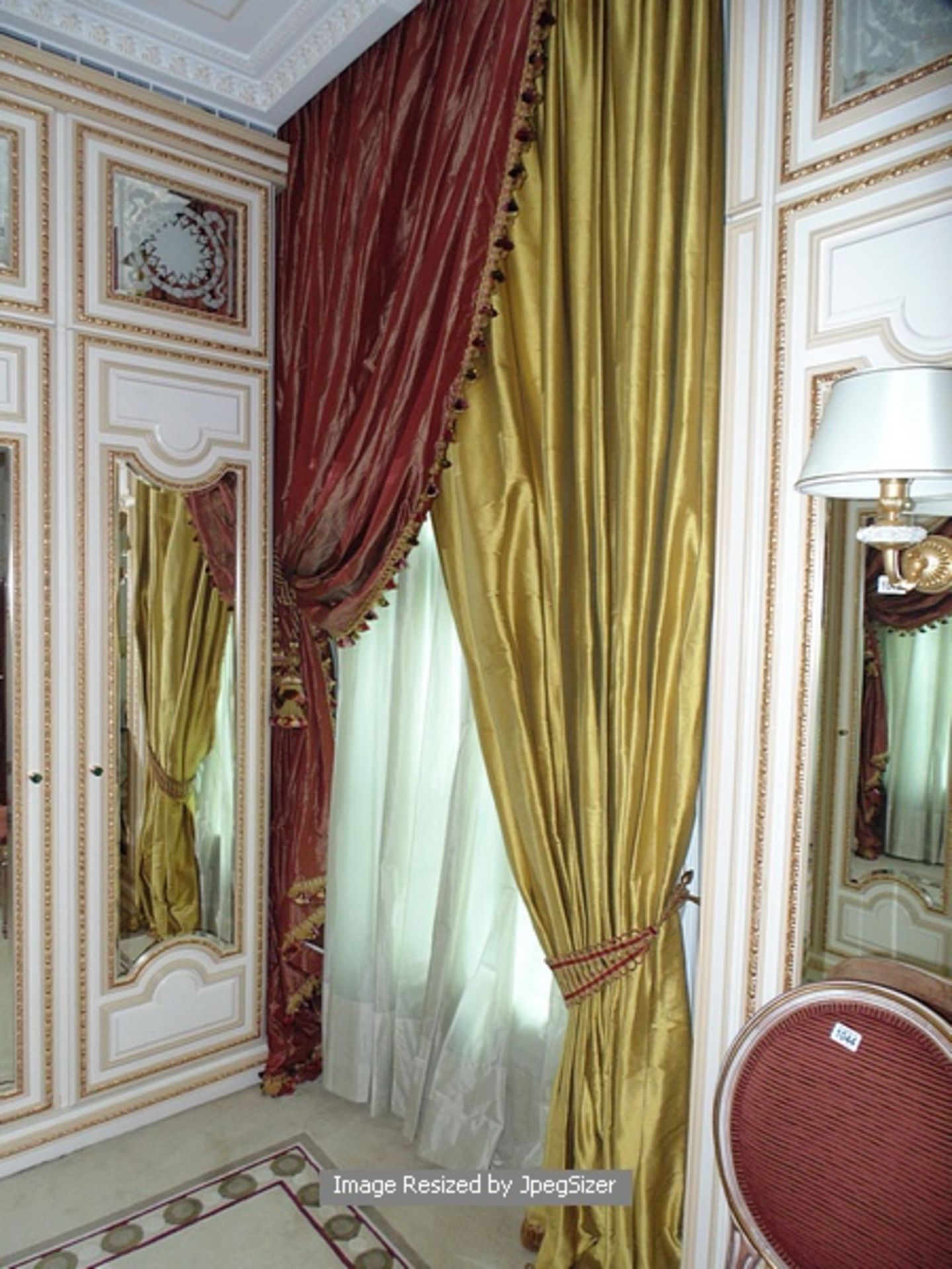 2 x asymmetrical curtains in gold and red supplied by Jacquard from Rudolph Ackermann`s series