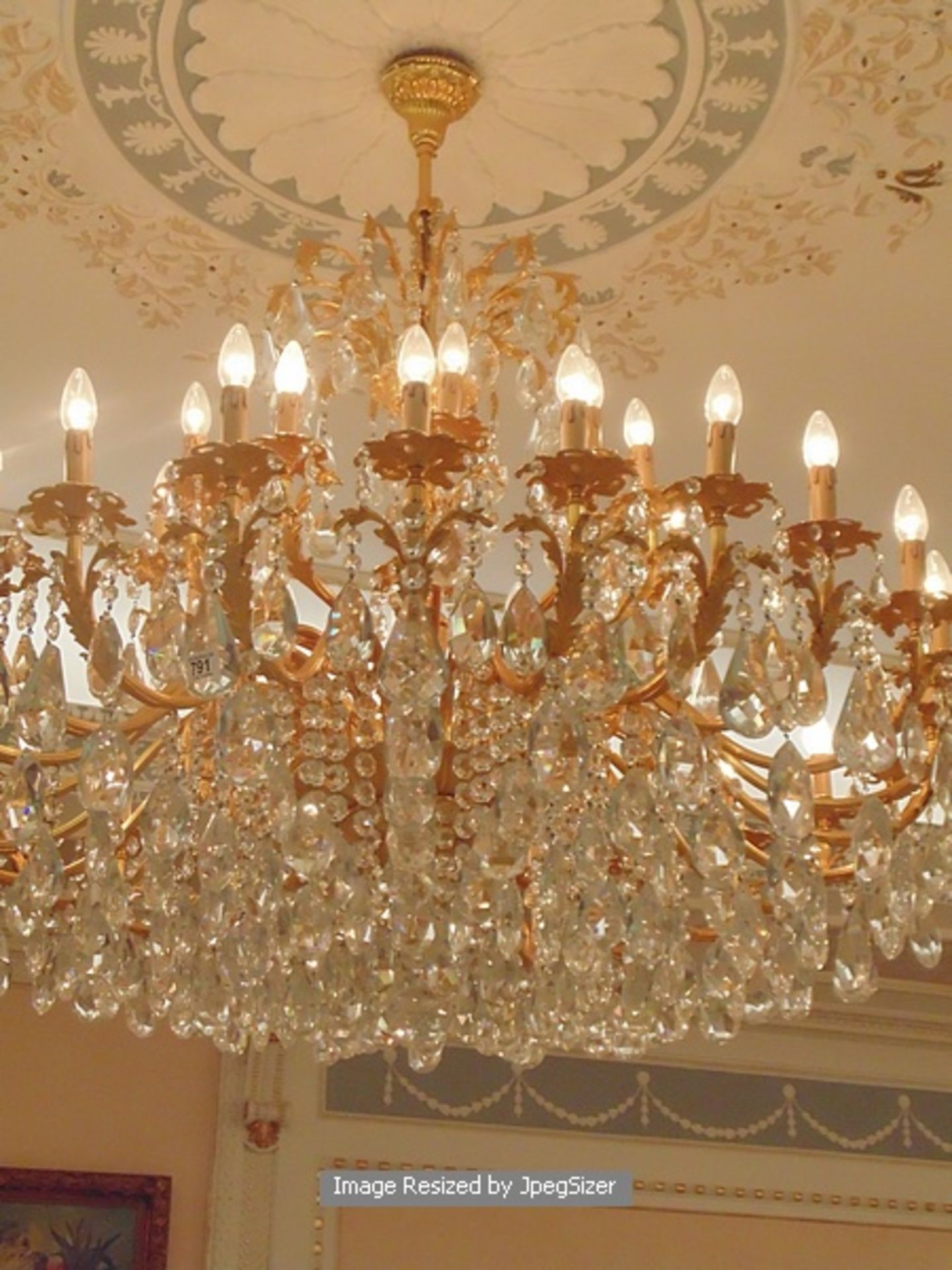 A gilt-brass and cut-glass chandelier, based on mid-18th century designs, the thirty six leaf-cast