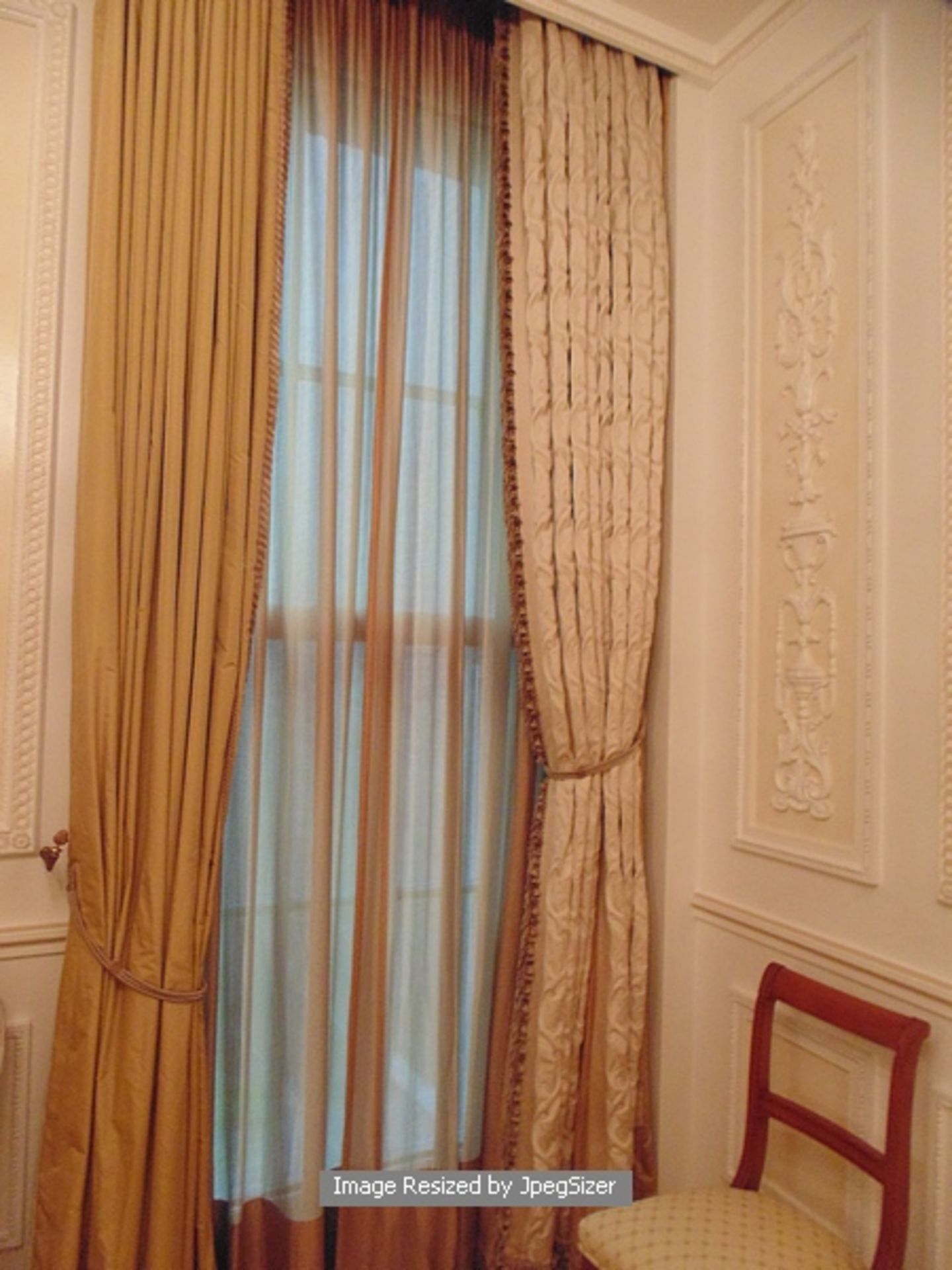 2 x asymmetrical curtains in gold and ivory supplied by Jacquard from Rudolph Ackermann`s series