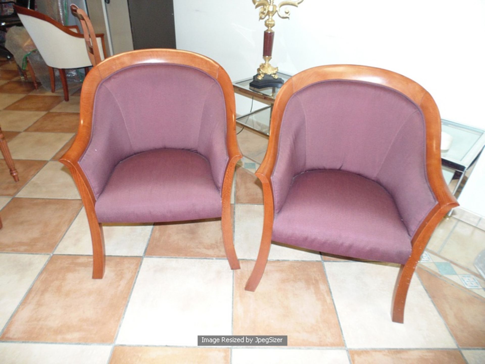 A pair of polished mahogany framed upholstered club chairs plum chenille type fabric