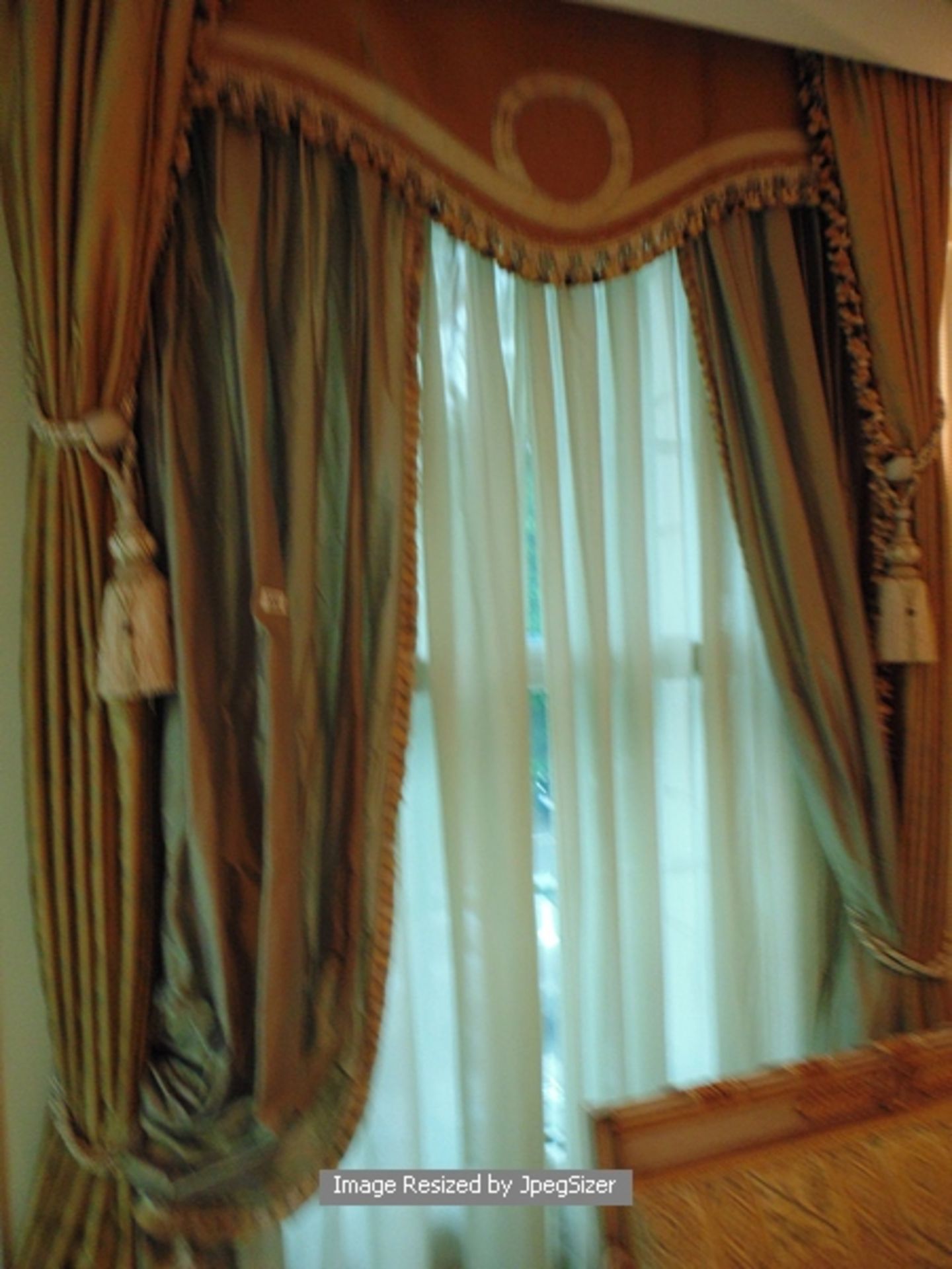 A pair of gold curtains supplied by Jacquard from Rudolph Ackermann`s A series design with elaborate
