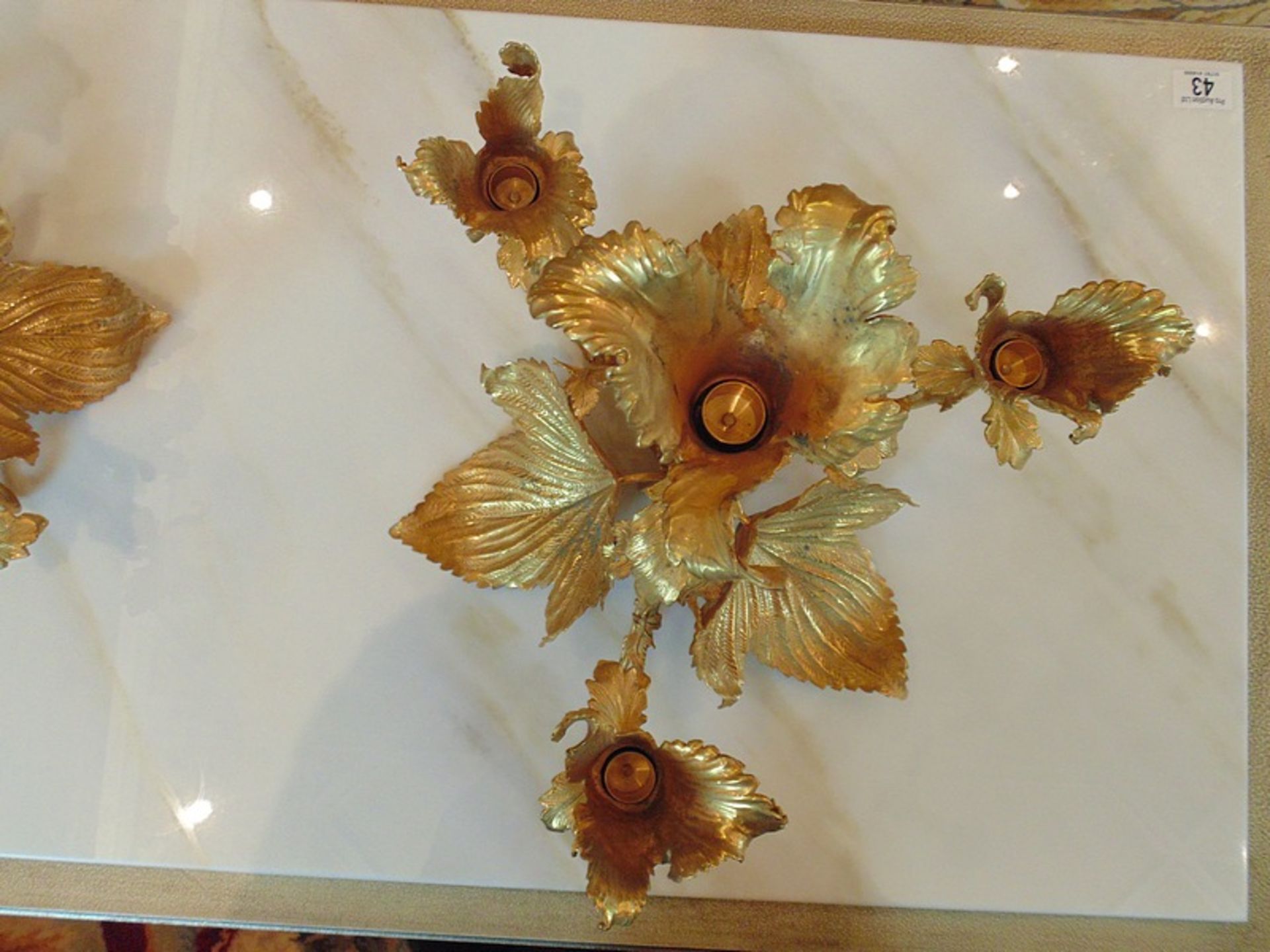 A pair of bronze with applied 24ct. gold leaf four branch candelabras in the form of a flower - Image 4 of 4