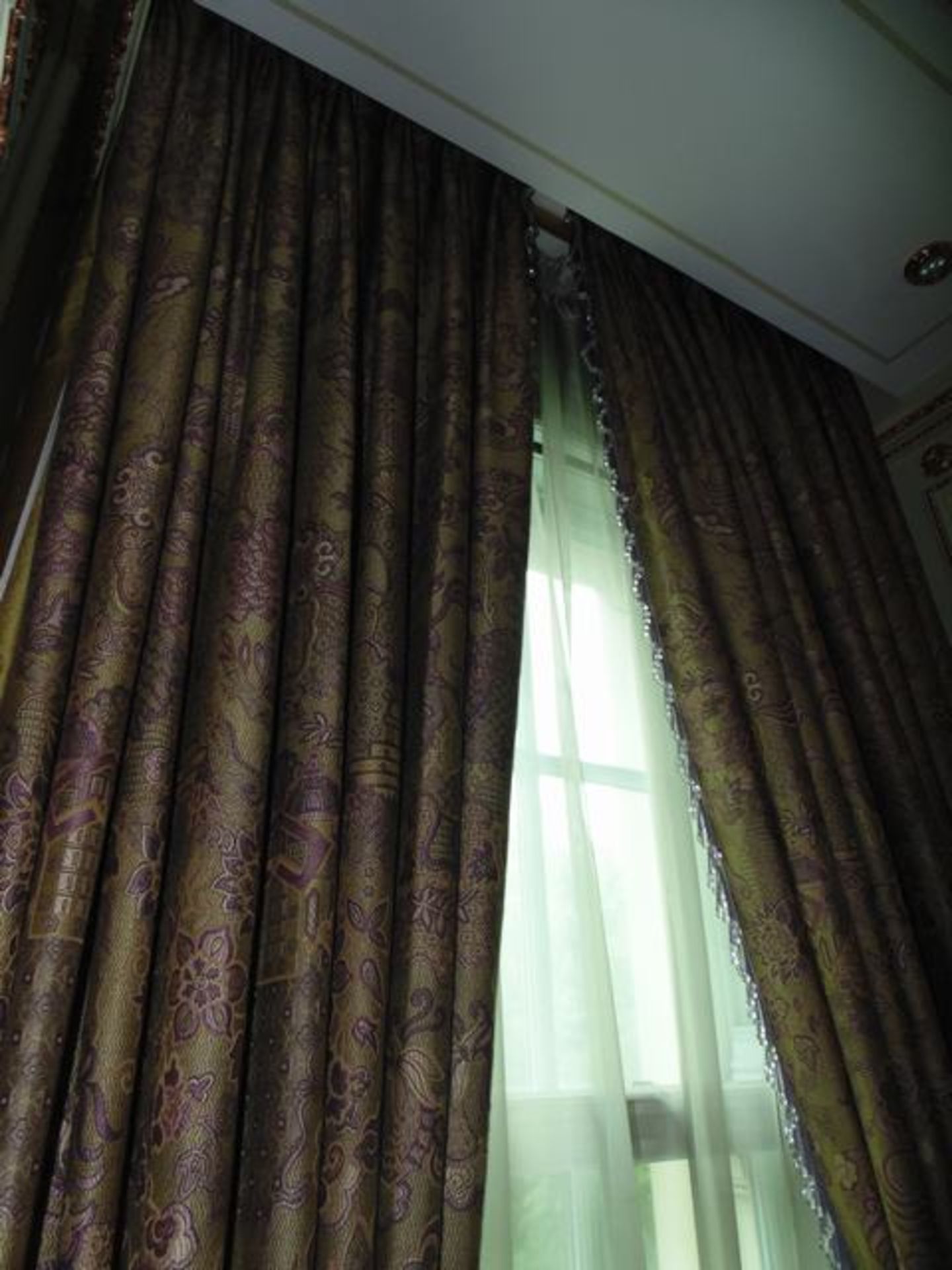 A pair of mauve and gold pattern curtains supplied by Jacquard, gold and mauve fabric from Marvi