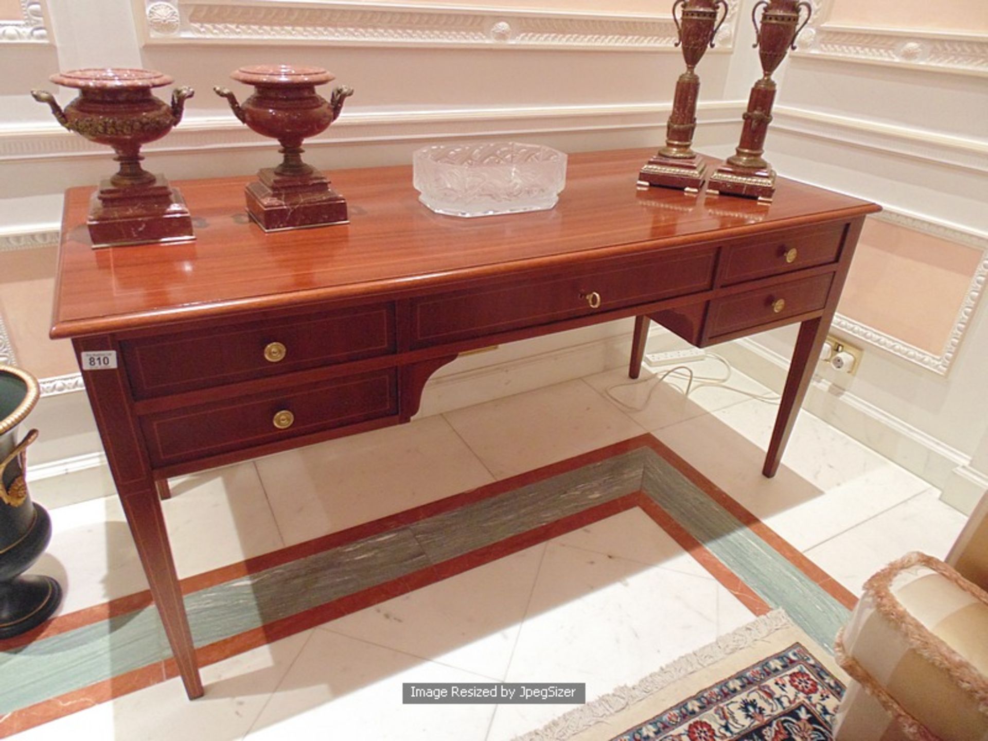 A handsome continental style mahogany five drawer writing desk the apron fitted with 5 drawers