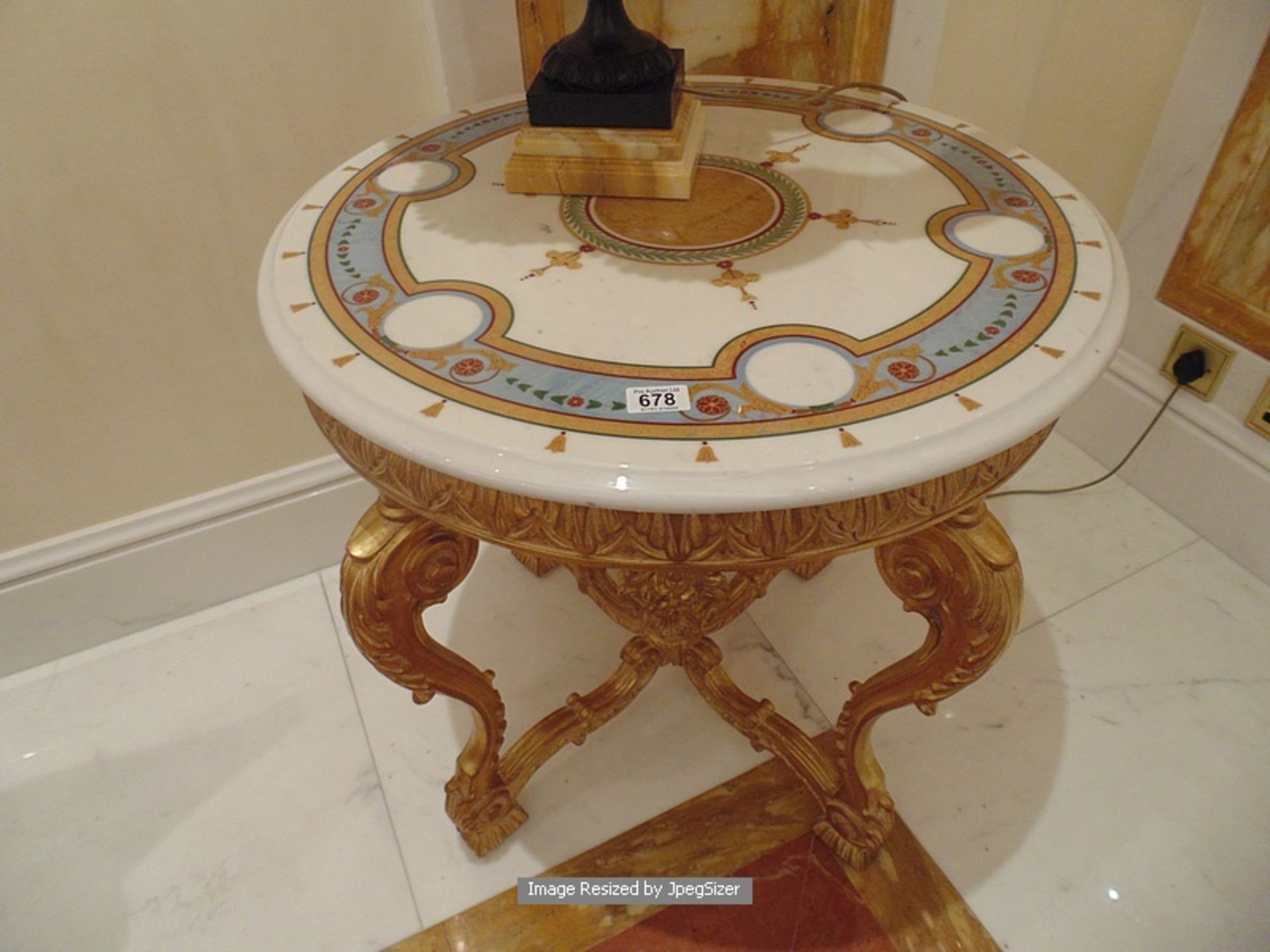 Italian Rococo style gilt round table with carved ornate stretcher and filigree apron with a round