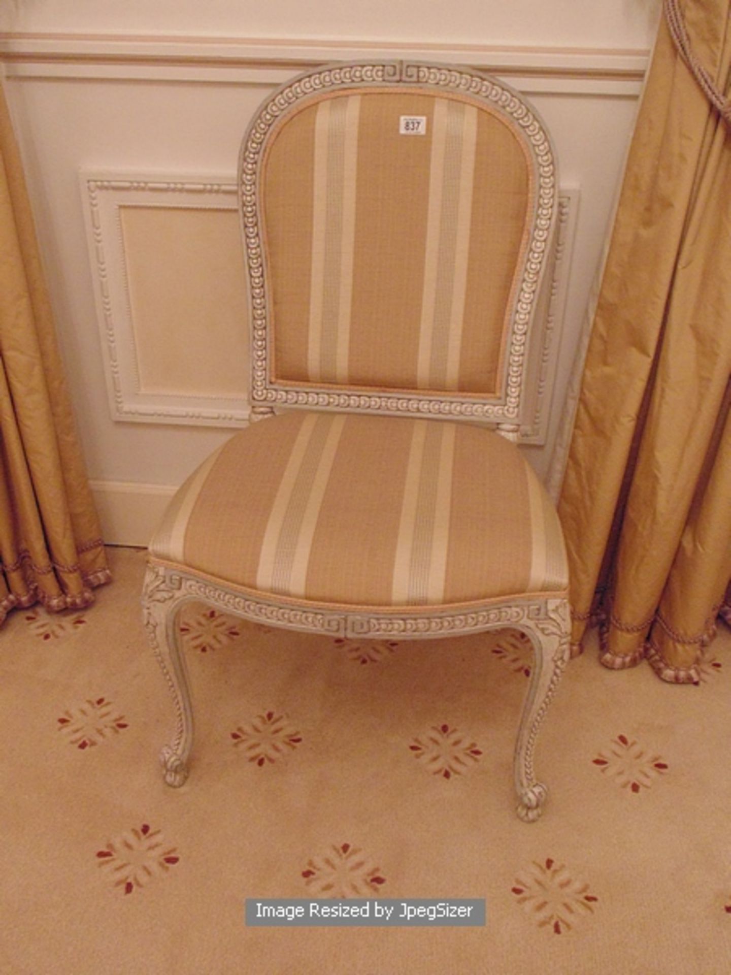 A continental carved, painted and parcel gilt side chair with a decorated frieze on cabriole