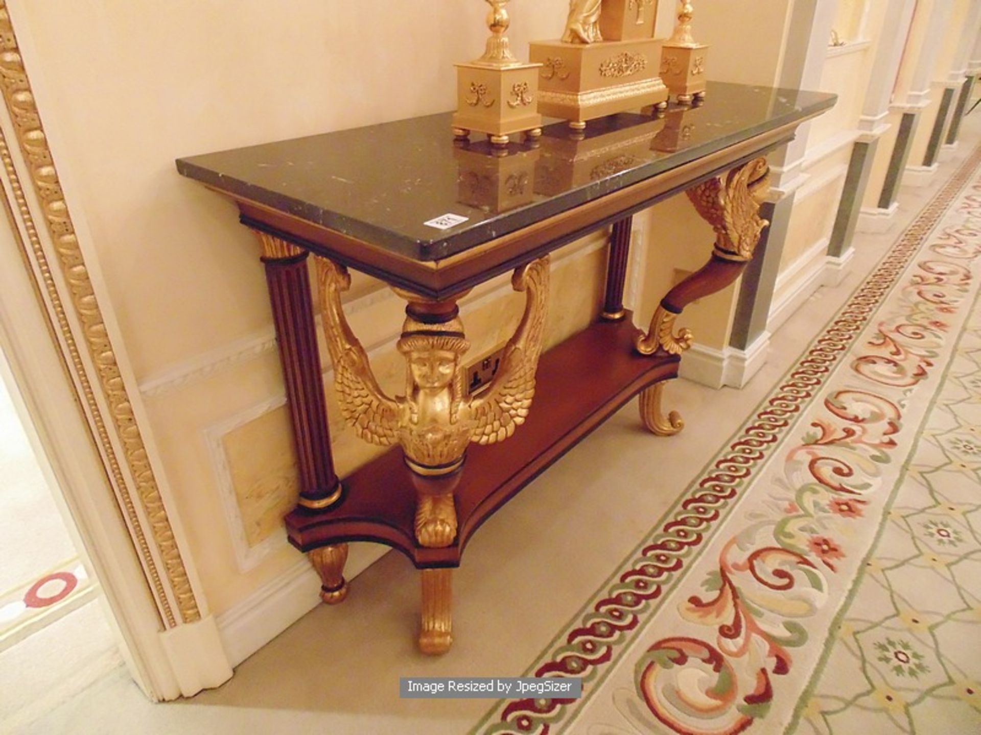 A mahogany and parcel-gilt console table in early 19th century Empire style, the mottled black - Image 2 of 3