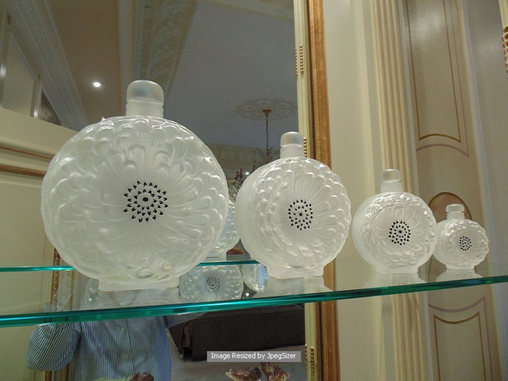 A set of four Lalique France Dahlia crystal perfume bottles based on an original Rene Lalique 1931