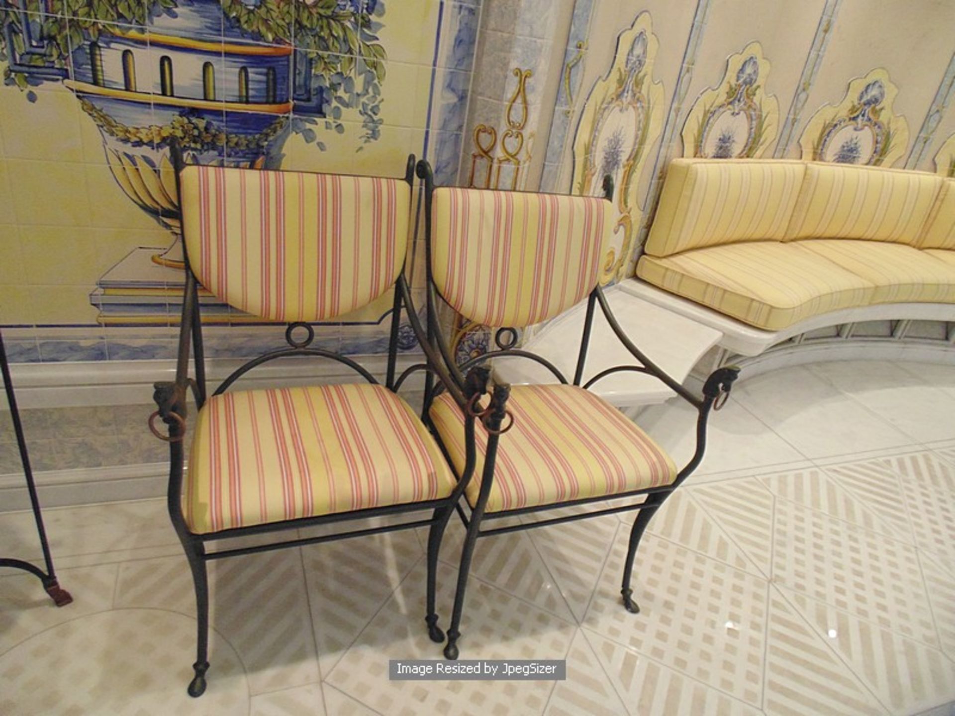 A pair of cast irons frame chairs with modern upholstered back rest and pad