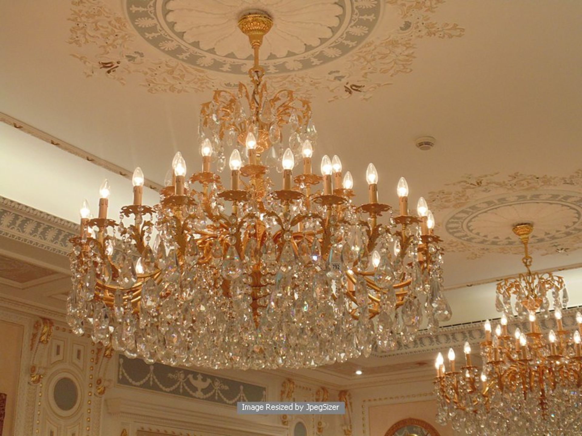 A gilt-brass and cut-glass chandelier, based on mid-18th century designs, the thirty six leaf-cast