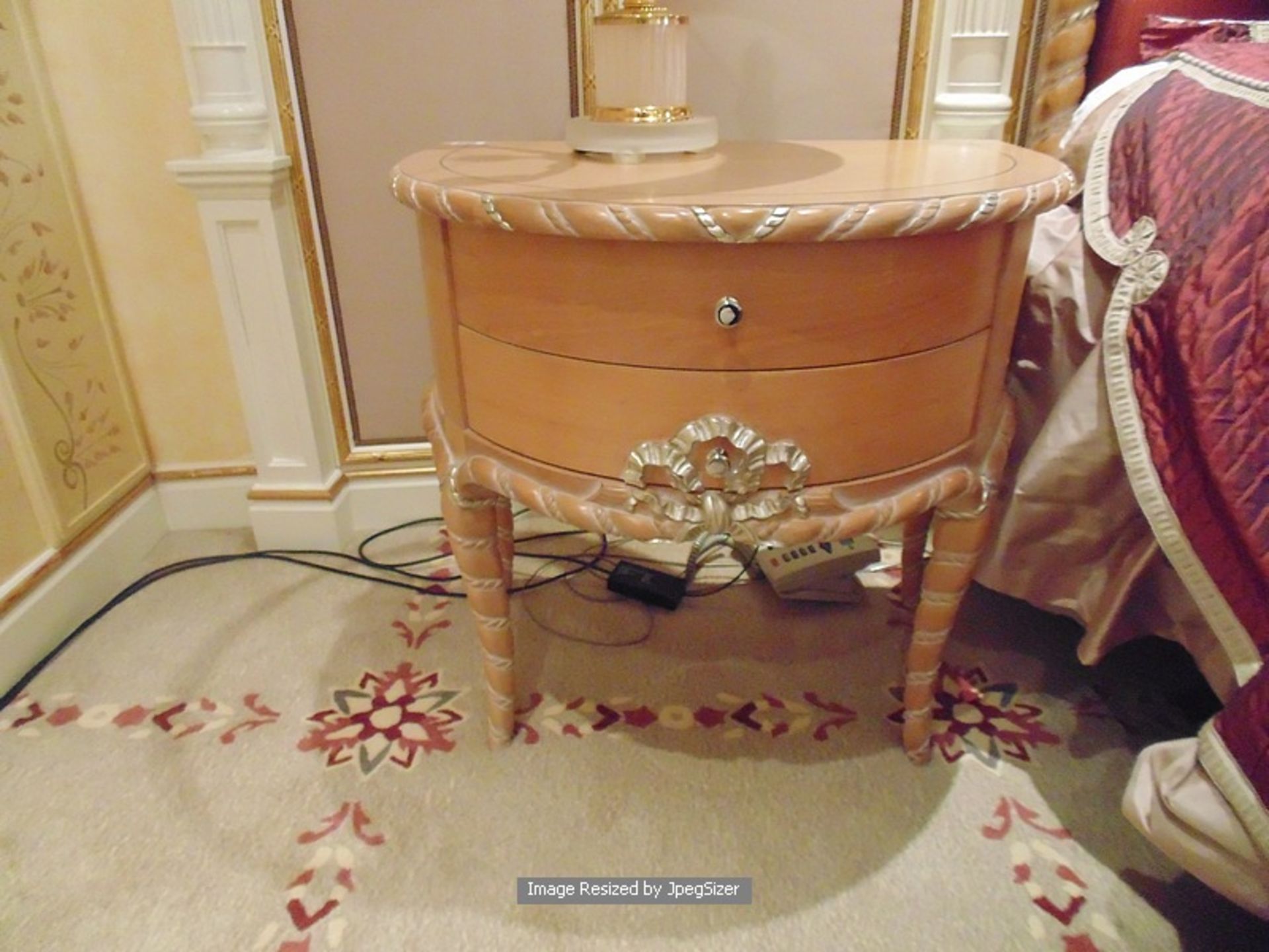 A pair of continental richly carved wooden nightstand tables two drawers the bow fronted unit is