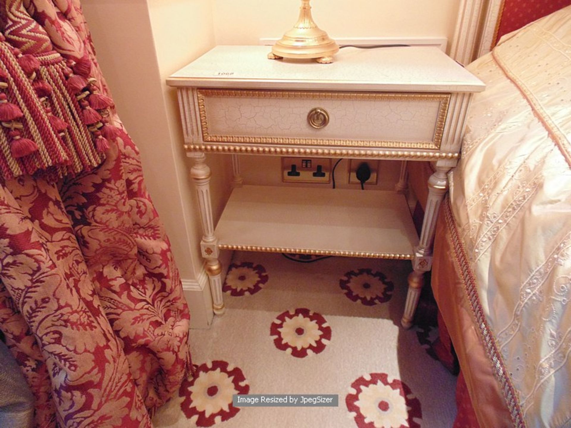 A pair of Neoclassical Italian painted and parcel gilt single drawer nightstand with under shelf