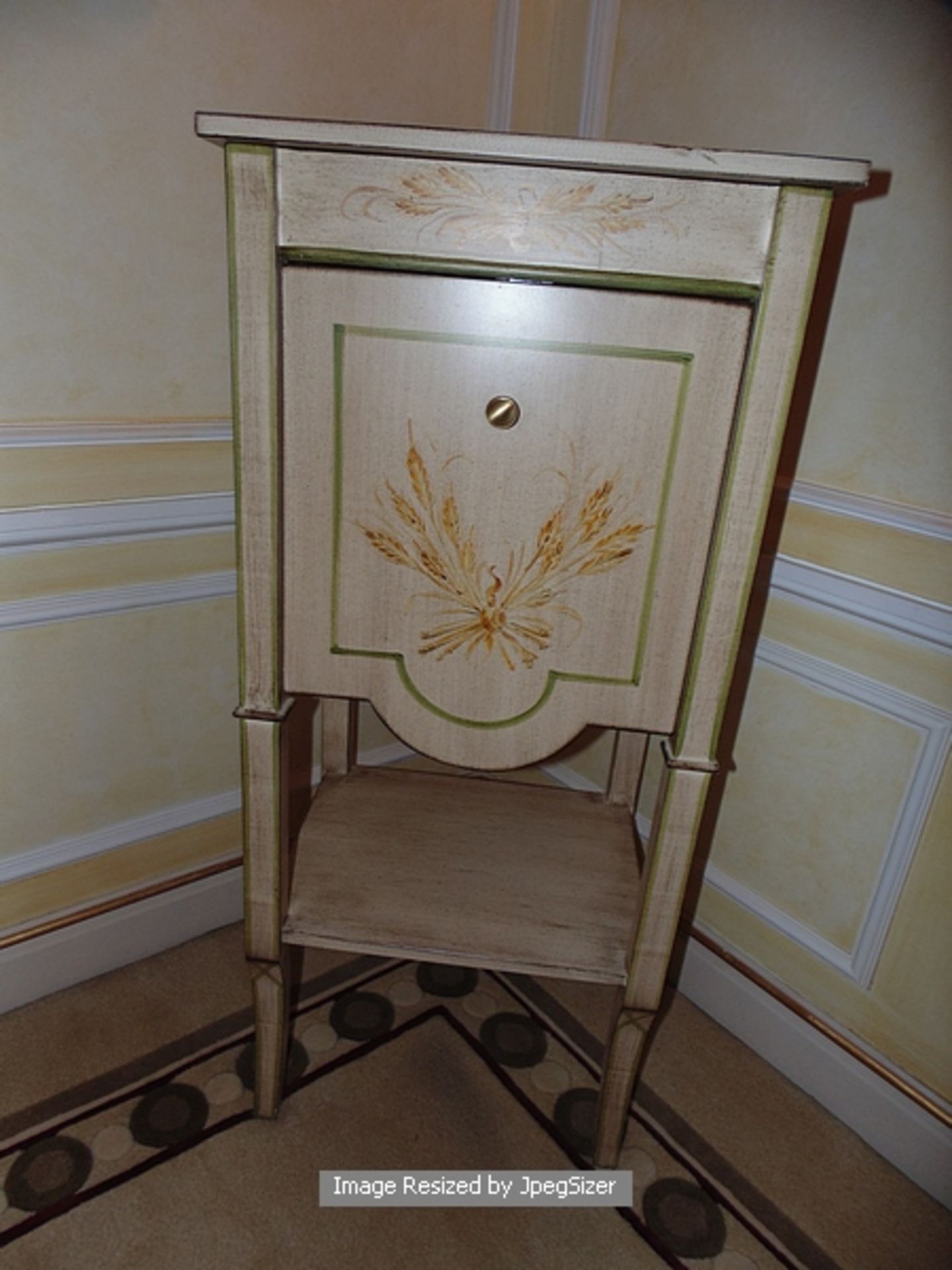 Painted and parcel gilt Louis XVI style commode , a single pull down cupboard above a single shelf