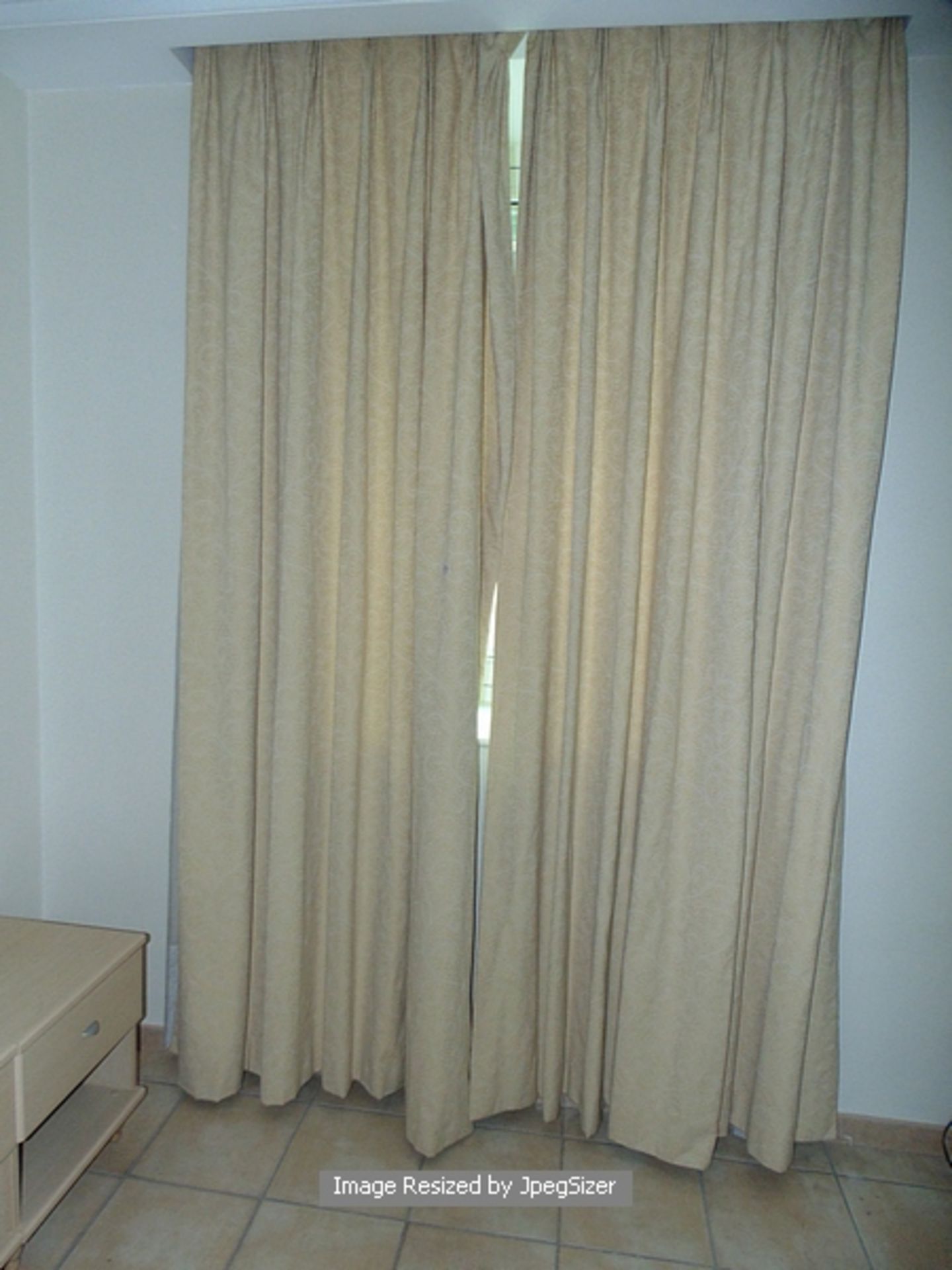 A pair of cream embossed and lined drapes 1500mm x 2750mm