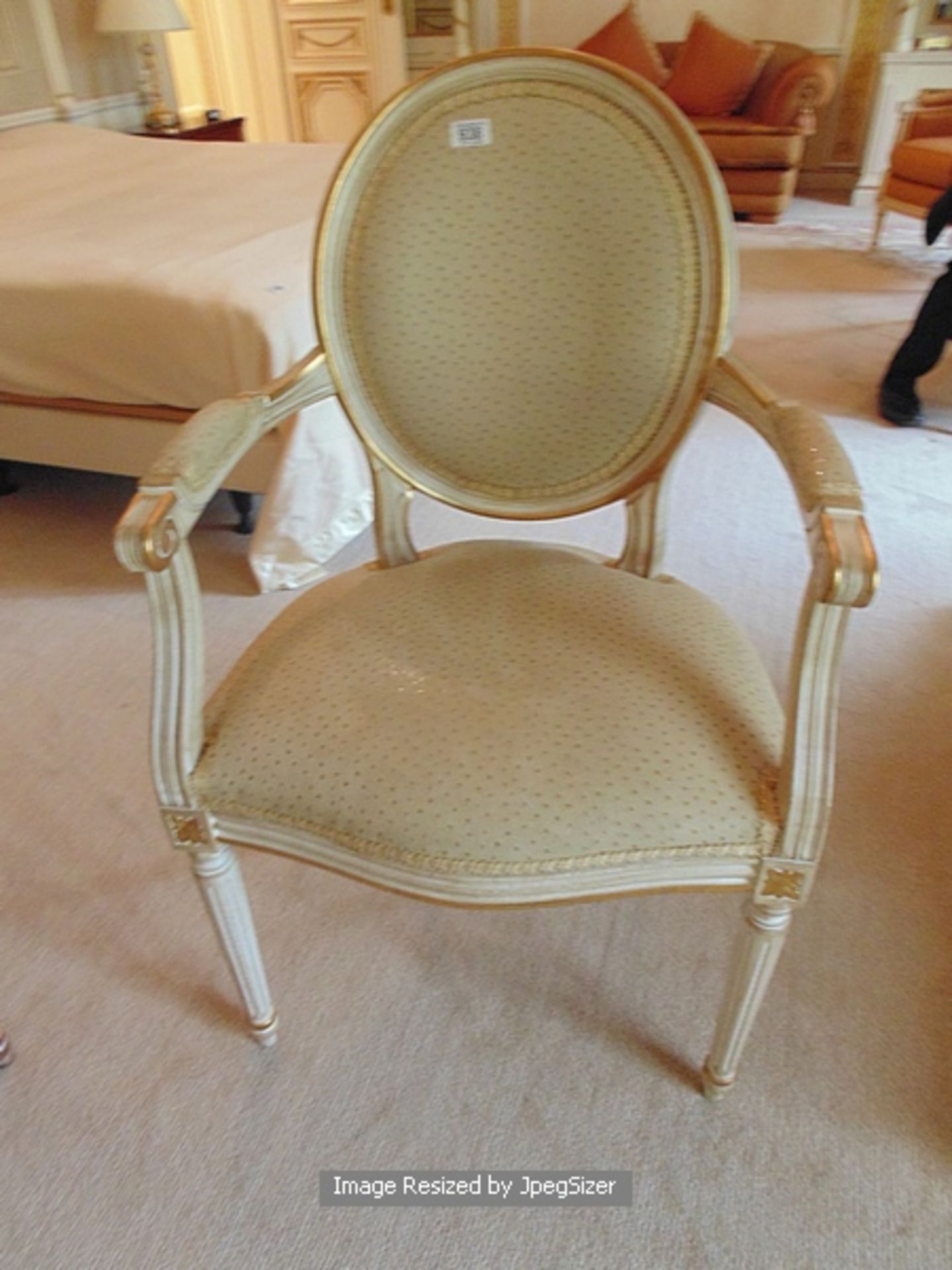 Neoclassical style arm chair with an oval padded back within a moulded frame headed the shaped and