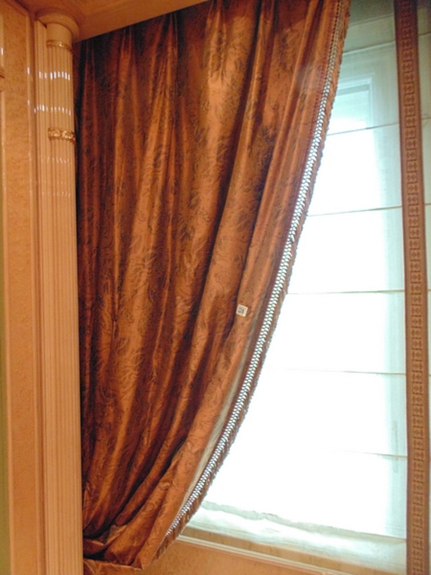 A set of four asymmetrical curtains (makes 2 pairs) of bronze gold curtains supplied by Jacquard