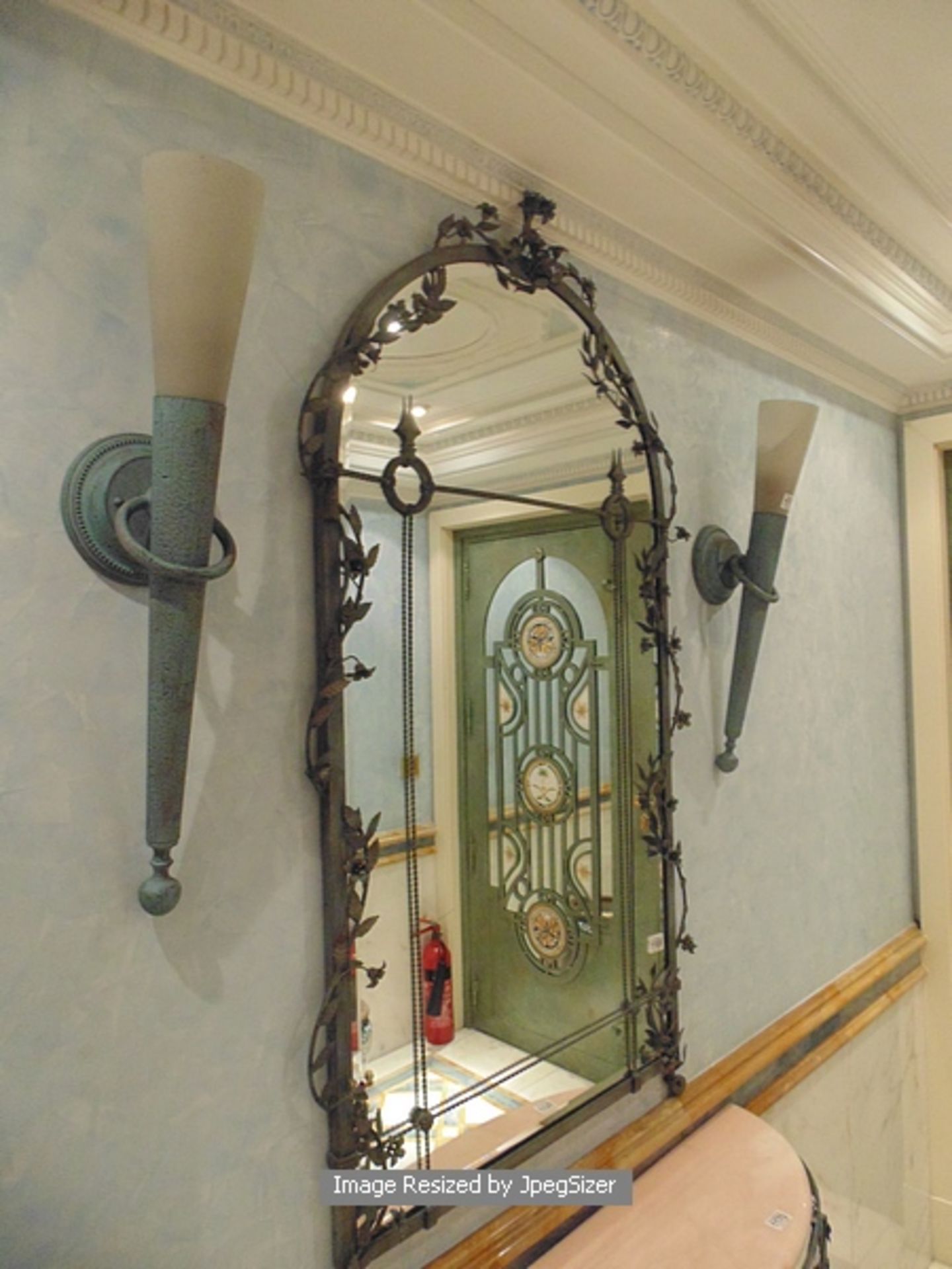 A cast metal framed arched top mirror 660mm x 1300mm