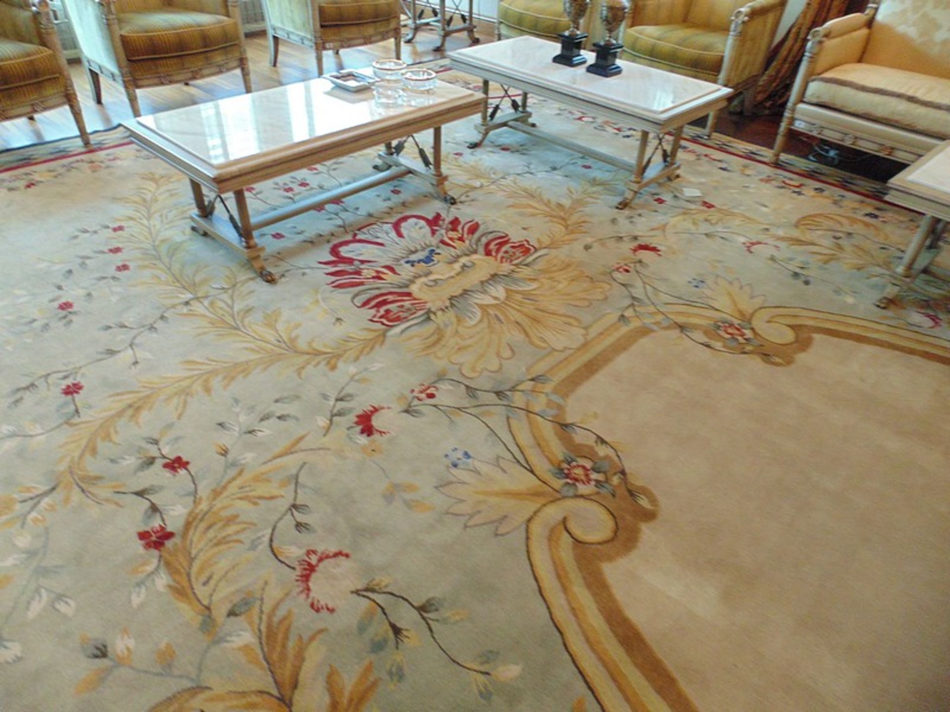 A sumptuous 100% pure new wool carpet 11.2m x 4.4m cream field with a floral central medallion and
