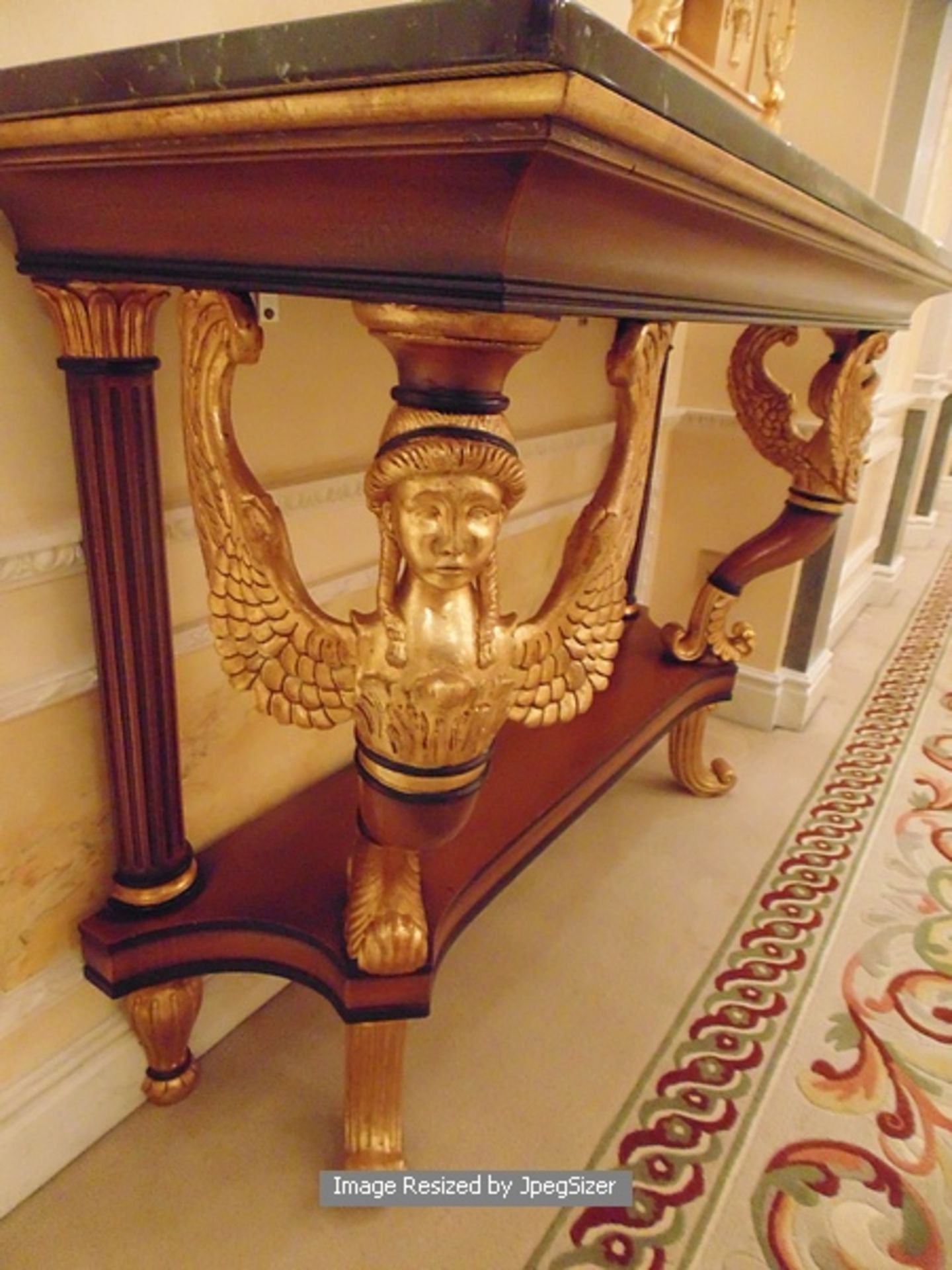 A mahogany and parcel-gilt console table in early 19th century Empire style, the mottled black - Image 3 of 3