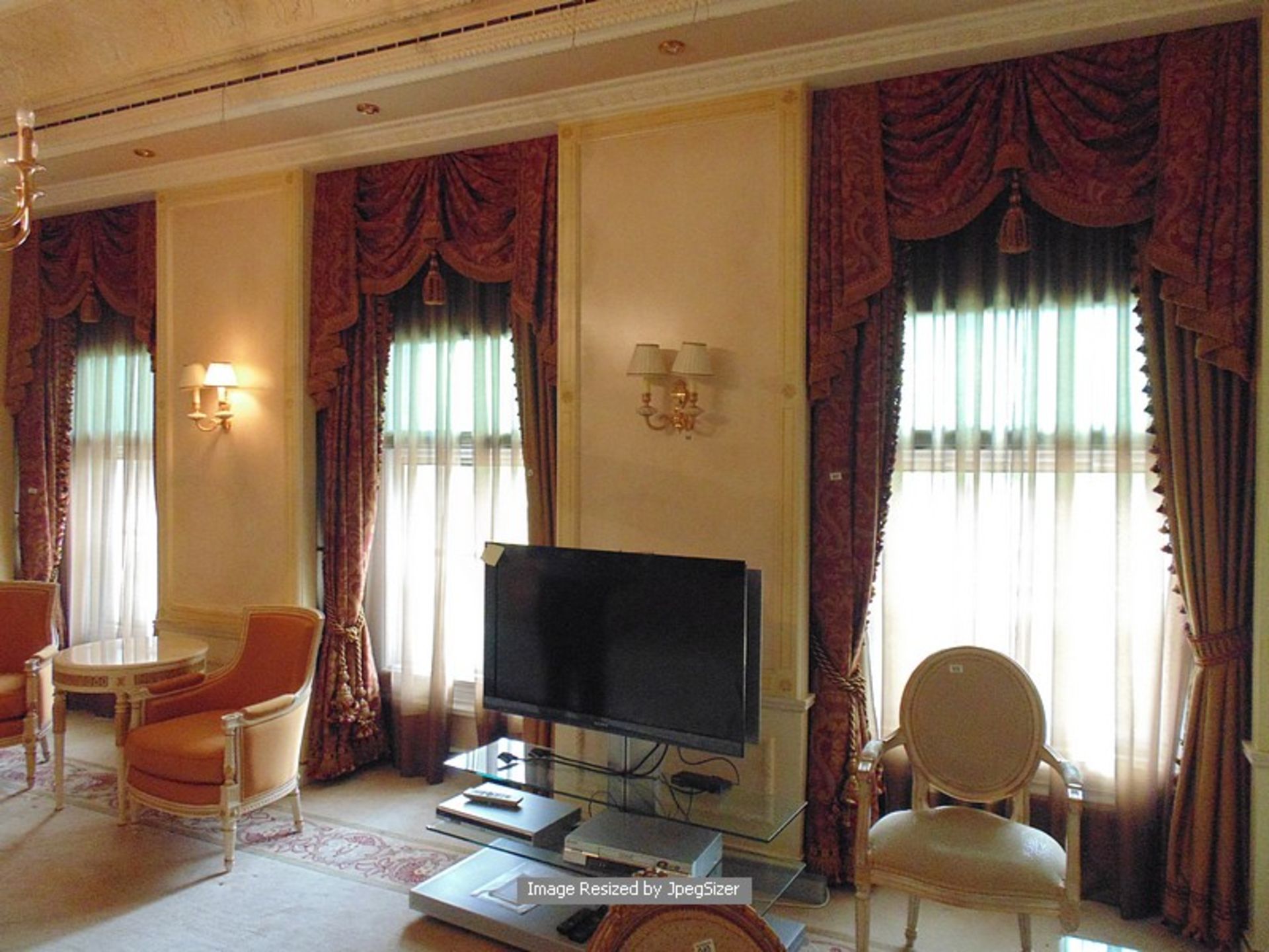 A pair of gold and burgundy curtains supplied by Jacquard from Rudolph Ackermann`s A series design