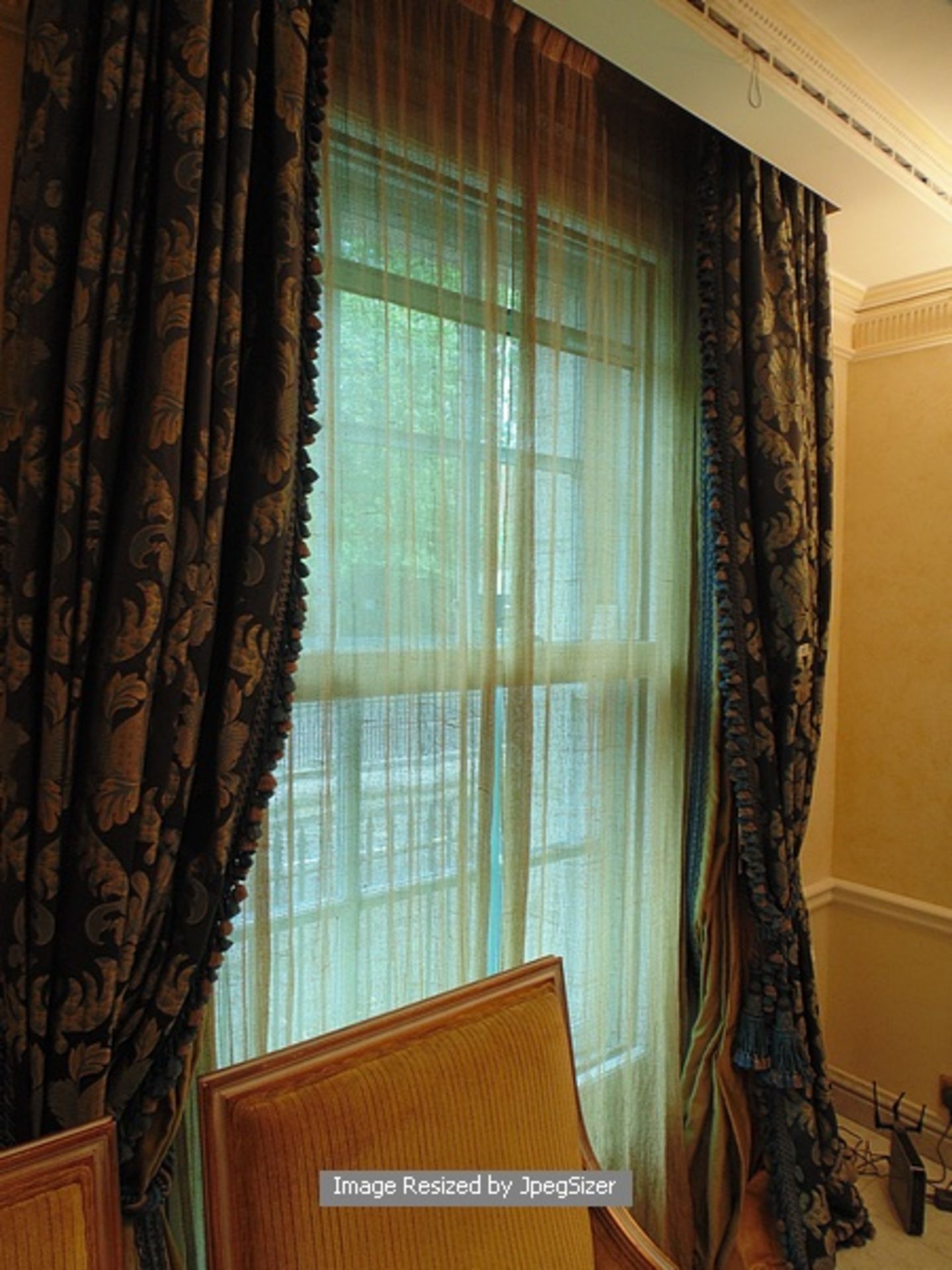 A pair of blue and gold patterned curtains supplied by Jacquard, blue and gold fabric from Marvi